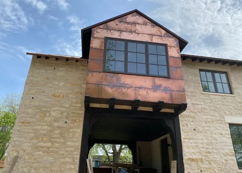 Copper metal panel facade on a stone building for Skylight Installation in Tequesta