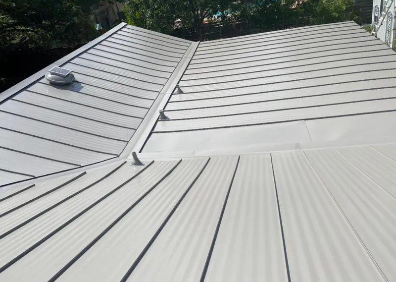 Solar attic fan installed on a metal roof for Roof Ventilation in Tequesta